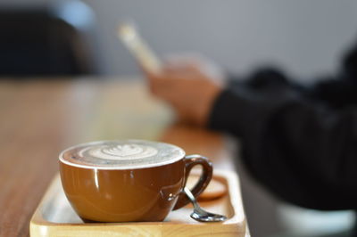 Close-up of coffee cup on table