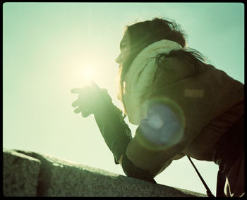 Low angle view portrait of boy against sky