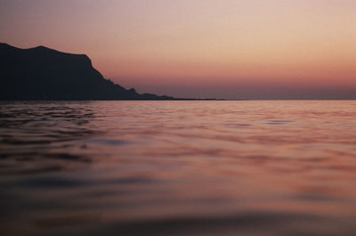 Scenic view of sea against clear sky at sunset