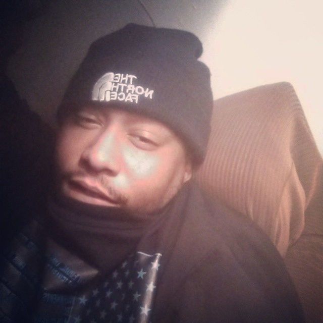 indoors, young adult, lifestyles, young men, person, front view, portrait, looking at camera, headshot, leisure activity, communication, casual clothing, text, mid adult, mid adult men, close-up, wall - building feature