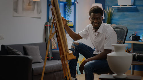 Young man sitting at home