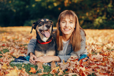 Portrait of woman with dog during autumn