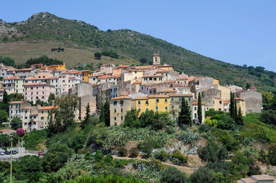 Houses and buildings against clear sky