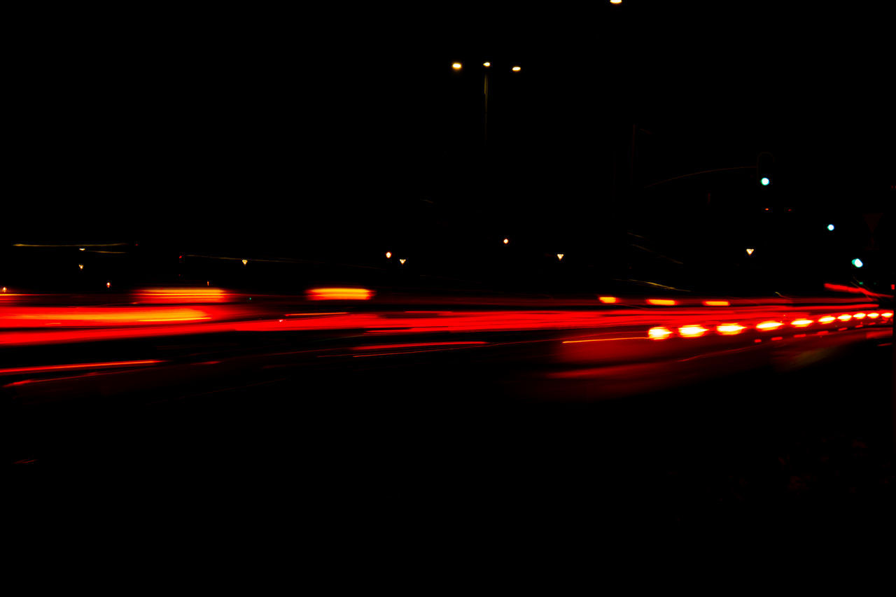 transportation, illuminated, mode of transportation, night, motion, car, motor vehicle, darkness, city, traffic, tail light, street, road, speed, long exposure, light, land vehicle, light trail, no people, blurred motion, headlight, on the move, lighting equipment, street light, city life, red, architecture, light - natural phenomenon, lighting, highway, evening, city street, outdoors, dusk, travel, red light, dark, copy space