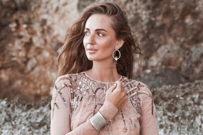 Portrait of beautiful young woman looking away