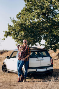 Portrait of a woman sitting on car