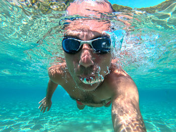 Portrait of man swimming in sea