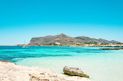 Scenic view of sea against clear blue sky