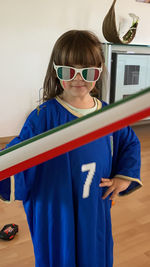 Portrait of young woman wearing sunglasses while standing against sky