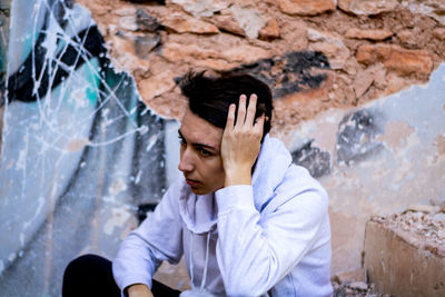 Thoughtful man sitting outdoors