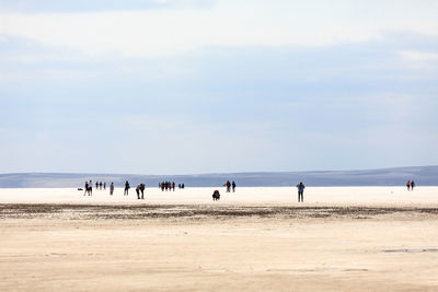 People on land against sky