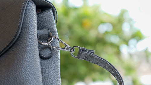 Close-up of chain tied up on metal