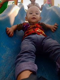 Full length of cute baby boy sitting outdoors