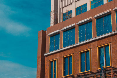 Low angle view of building against blue sky