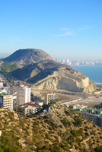 High angle view of buildings by sea against sky