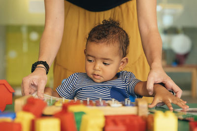 Portrait of cute boy with toy on table