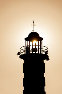 Low angle view of silhouette statue against sky during sunset