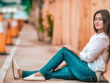 Young woman sitting outdoors