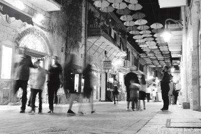 People walking in illuminated city