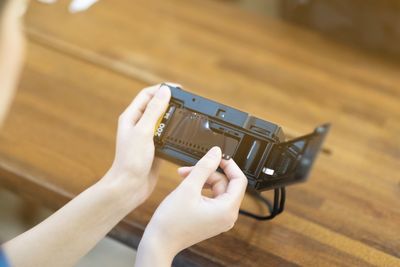 Midsection of woman using mobile phone on table