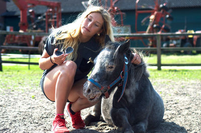 Young woman with horse on field