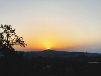 Scenic view of silhouette mountains against sky at sunset