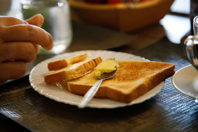 Close-up of hand holding cake