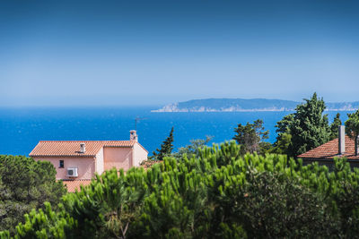 Scenic view of sea by buildings against sky