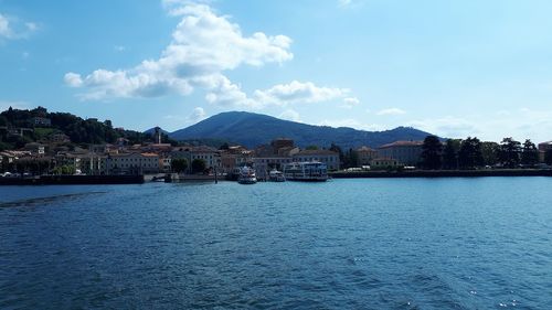 Scenic view of sea by buildings against sky