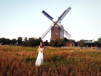 Woman standing on grassy field