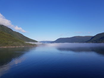 Scenic view of lake against blue sky