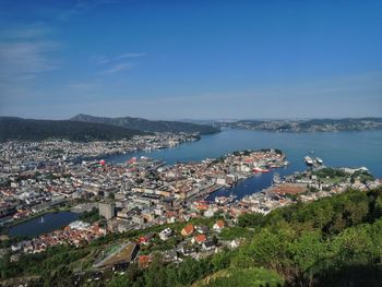 High angle view of townscape by sea against sky