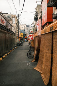 Bicycle on street against buildings in city