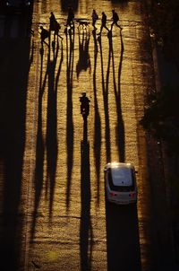 High angle view of people and vehicles on street in city