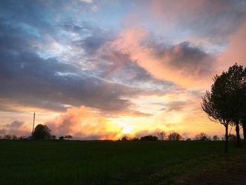 Scenic view of field against sky during sunset