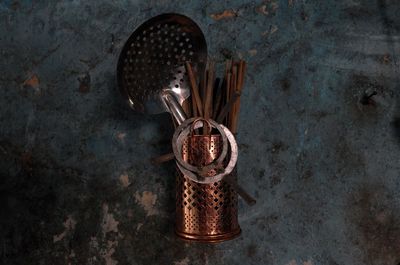 Close-up of cooking utensils hanging against wall