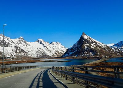Scenic view of snowcapped mountains against clear blue sky