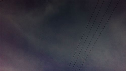 Low angle view of cables against sky