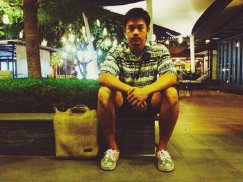 Portrait of young man sitting on seat