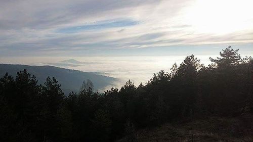 Scenic view of mountains against cloudy sky