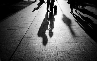 Low section of people walking on road