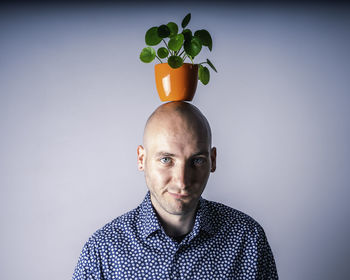 Portrait of young man against gray background
