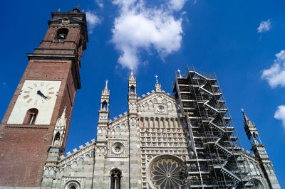 Low angle view of bell tower against blue sky