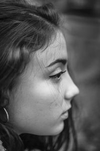 Close-up of teenage girl looking away  