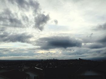 Cityscape against cloudy sky