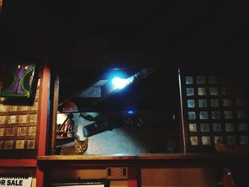 Illuminated books on shelf at night