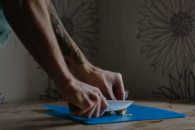 Home cooking, male hands, cuts fresh garlic, close-up