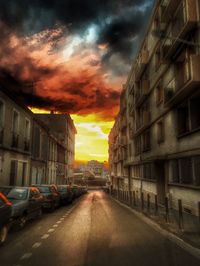 Road passing through city against cloudy sky