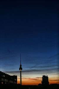 Low angle view of communications tower against sky