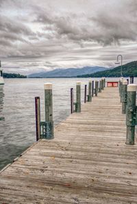 Wooden pier on sea against sky